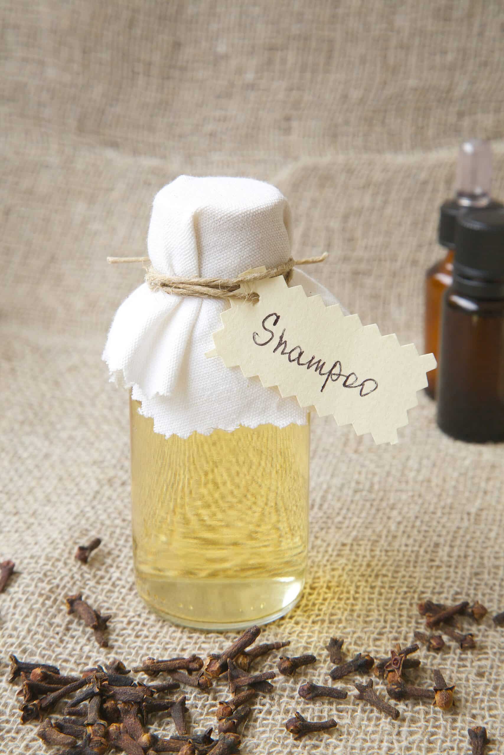 Shampoo,With,Clove,Essential,Oil.,Cloves,Buds,In,The,Background.
